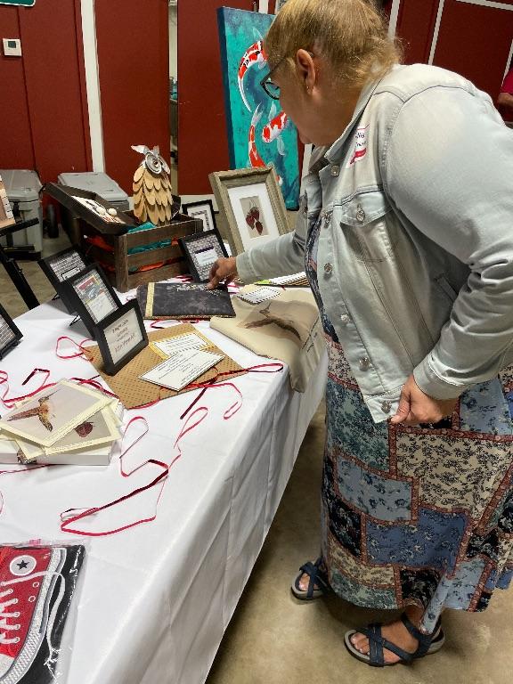 Phyllis Jacobs Trickey inspecting door prizes