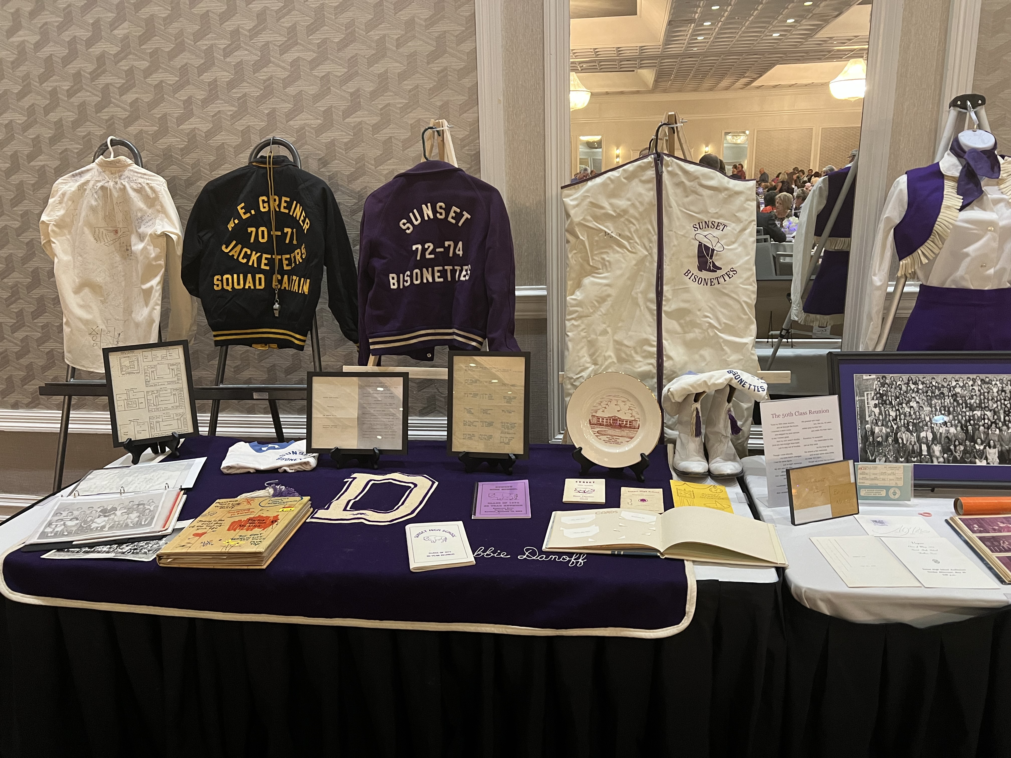 One of the many memorabilia tables. And YES, that is an original Bisonette uniform and garment bag! Don’t miss the Lida Hooe Elementary classmate signature shirt from ’69 too.