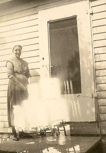 Grandma Rogers at the farmhouse side door.