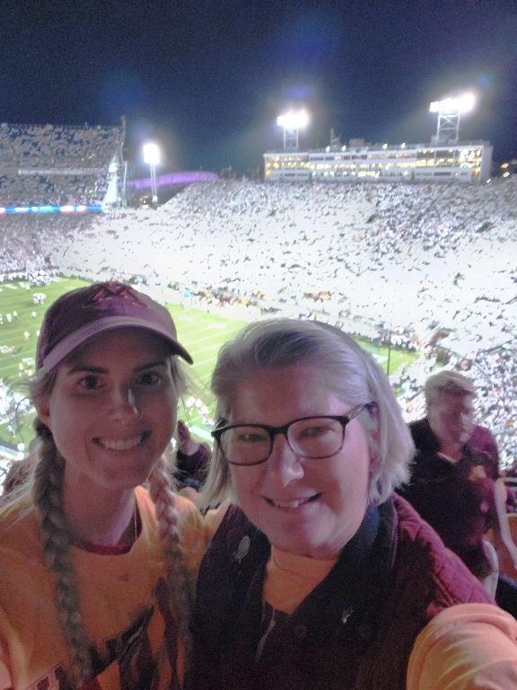 Debi Herzan Parker: My oldest daughter and I at the Minnesota vs Penn State White Out football game, October 2022.