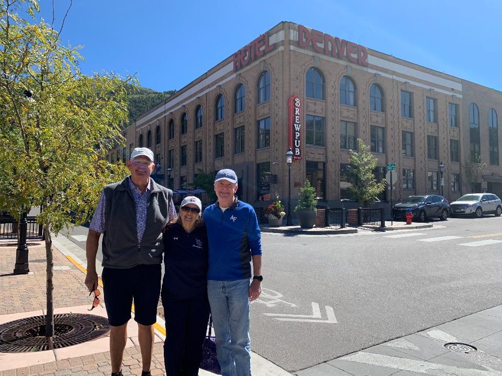 Touring the old downtown; Kim & Pat (‘69) Harden, Chris Campbell; Hotel Denver and Depot behind